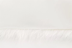 Close-up of white silky fabric and fluffy faux fur trim on a French style coat