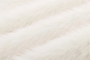 Close-up of premium white faux fur texture showing long soft fibers on a jacket