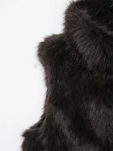 Close-up detail of luxurious dark brown faux fur texture and long plush fibers of the vest