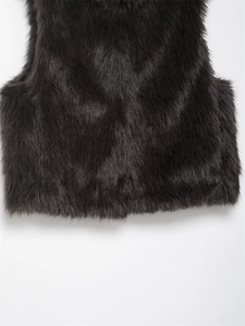 Detail of faux fur vest showing soft black long-pile texture and hemline craftsmanship