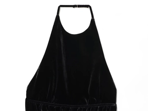 Detailed macro view of black velvet halter top showing soft texture and metal buckle detail