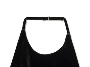 Detail of black velvet halter top featuring a silver metal buckle and tie-neck closure