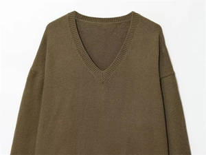 Close-up of V-neckline and fine ribbed knitting on dark olive green autumn sweater