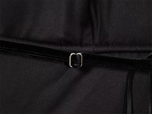 Detail of black velvet shoulder strap with adjustable silver metal buckle on a chic top