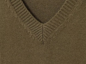 Close-up of olive green V-neckline with ribbed knit texture on stylish sweater