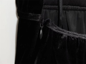 Macro shot of high-quality invisible zipper on premium black velvet clothing fabric