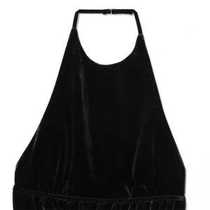 Women's black velvet halter top with adjustable neck strap and shiny texture