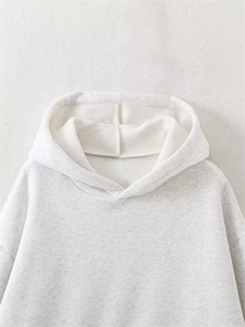 Detail of light grey hooded sweatshirt showing soft fleece lining and stitching