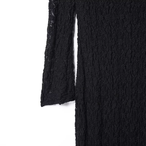 Detailed close-up of intricate hollow lace texture on a sexy black dress sleeve