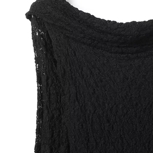 Detail shot of black floral lace fabric with intricate mesh texture and scalloped neckline