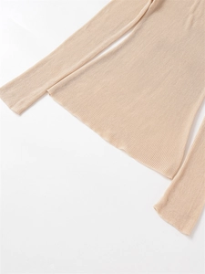 Detailed view of apricot ribbed knit fabric with delicate texture on long sleeve top