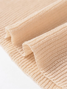 Macro shot of cream knit fabric texture with ribbed mesh pattern for breathable texture