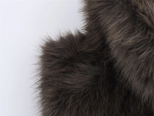 Macro shot of dense dark brown faux fur texture showing soft and long fibers