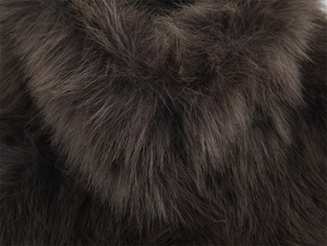Close-up of thick brown faux fur texture with soft and dense synthetic fox hair detail