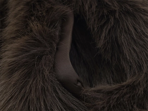 Detail of dark brown faux fur texture and smooth twill binding on fashion vest