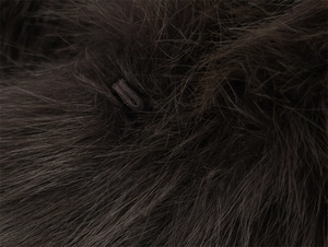 Macro detail of dark faux fur texture featuring a metal hidden hook-and-eye closure