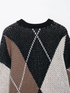 Detailaufnahme des Strickpullovers mit Rautenmuster und geripptem Rundhalsausschnitt