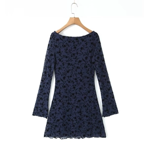 Detailed view of navy blue mesh mini dress featuring black floral flocking and flared sleeves