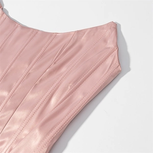Close-up of pink satin corset top featuring vertical boning and smooth pearlescent texture