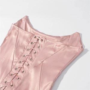 Detail of pink satin corset featuring lace-up design and silver metal eyelets