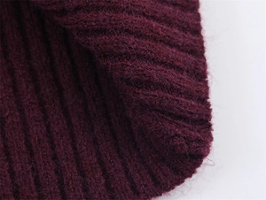 Dettaglio del tessuto a maglia a coste rosso vino con texture morbida e lanuginosa