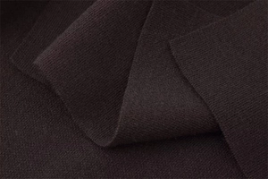 Close-up of the dark brown knitted fabric texture and soft wool blend material
