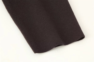 Close-up of dark brown knit fabric showing detailed fine-knit texture and smooth stitching