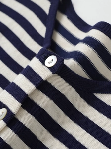 Detail of navy stripe knit cardigan featuring premium pearl buttons and fine texture