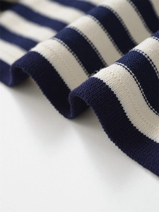 Close-up of blue and white striped knit fabric texture with soft premium cotton finish