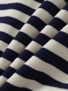 Macro shot of navy and cream striped knit fabric texture on a casual cardigan jacket
