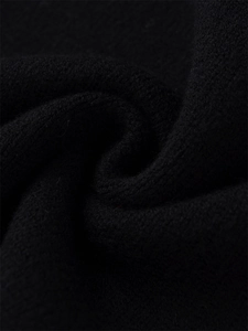 Close-up of black knit fabric showing premium texture and soft cashmere wool fibers