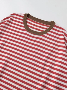 Detailed view of the red and white striped knit top with brown ribbed neckline