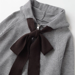 Fashionable grey knitted hoodie for women with oversized brown bow and zipper detail