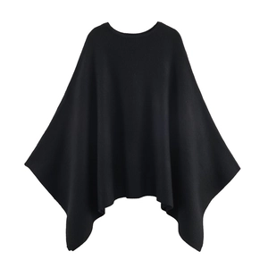 Women's minimalist black knitted poncho wrap with elegant round neck and draped hemline
