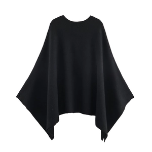 Women's black knit cape coat with elegant round neck and irregular wavy hem on white background