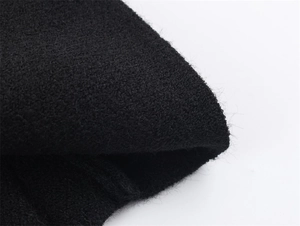 Macro shot of high-quality black knit fabric showing the dense texture and soft fibers