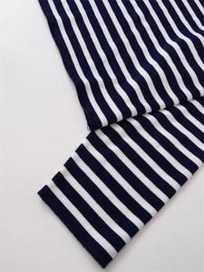 Détail macro du tissu en maille rayée bleu marine et blanc avec une texture soignée