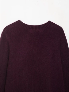 Gros plan sur l'encolure ronde côtelée de ce pull en maille à manches longues violet foncé