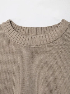 Macro detail of brown knit sweater featuring reinforced double-layered ribbed crew neck