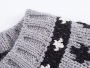 Detailed macro view of knitted ribbed cuffs and black and white jacquard pattern texture