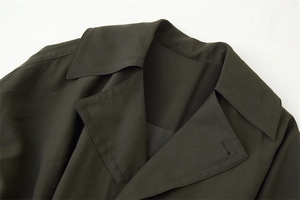Detail of double-layer notched lapel on deep olive twill trench coat for women