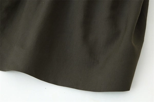 Macro shot of the dark green twill woven fabric showing premium texture and density