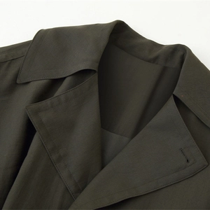 Deep olive green trench coat with lapel collar and premium high-density twill fabric details