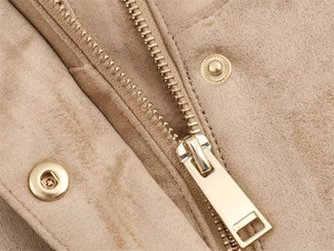 Close-up of golden metal zipper and snap button on beige faux suede jacket