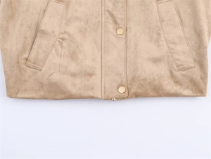 Detailed close-up of camel faux suede jacket featuring golden snap buttons and side pockets