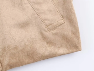 Detailed macro view of camel suede jacket featuring reinforced side stitching and pocket edge
