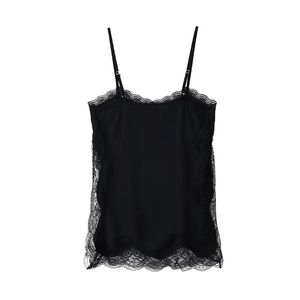 Detailed close-up of delicate black lace trim and silk fabric on a camisole top