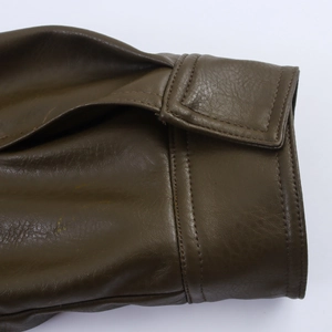 Detail of sleeve cuff with adjustable strap and stitching on dark brown leather jacket