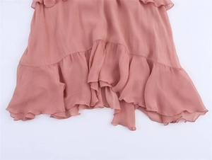 Detail of tiered ruffle hem and texture on a dusty rose French style chiffon dress