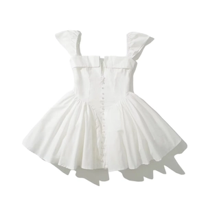 Detail of square neckline with ruffle straps and decorative buttons on white dress